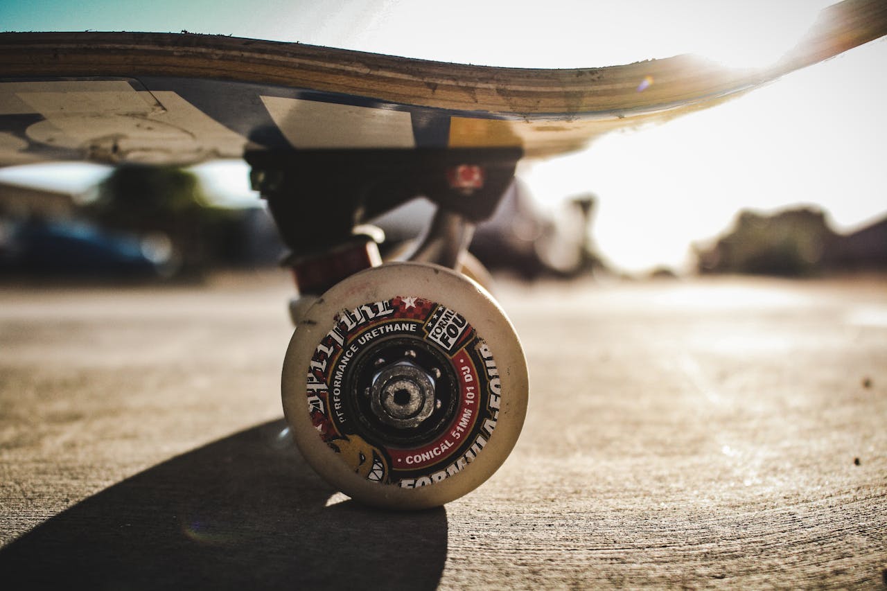 Detailed shot of a skateboard wheel on concrete outdoors. High-quality focus and lighting.